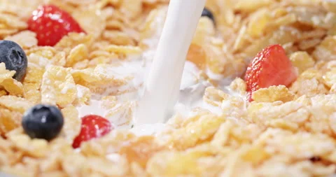 Corn flakes, berries, natural milk - the concept of a healthy diet. Stock Footage 219888725