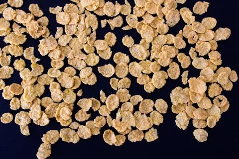 Corn flakes on a black background Photos
