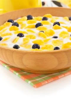 Corn flakes in bowl on white Stock Photos