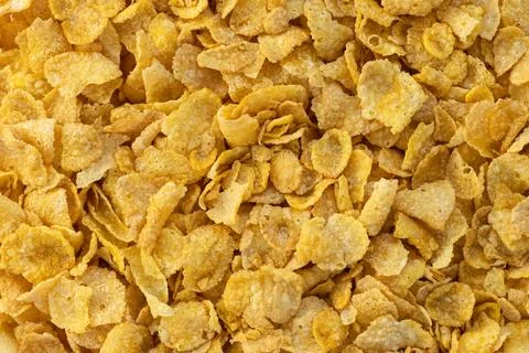 Corn flakes cereal texture background. Healthy crunchy breakfast. Stock Photos