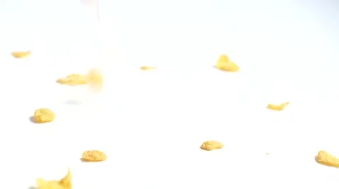 Corn flakes cereals dropping at table Stock Footage 64801336
