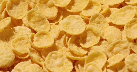 Corn flakes close-up. healthy crispy breakfast. yellow flakes under sunlight Stock Footage 241370326