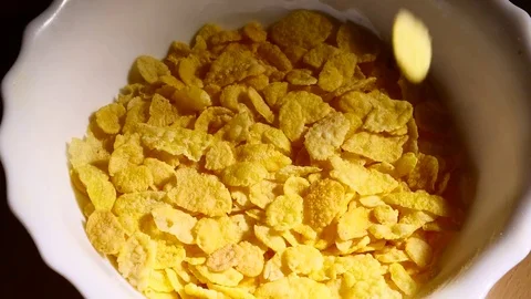 Corn flakes falling into bowl of corn flakes slowmo Stock Footage 84053282
