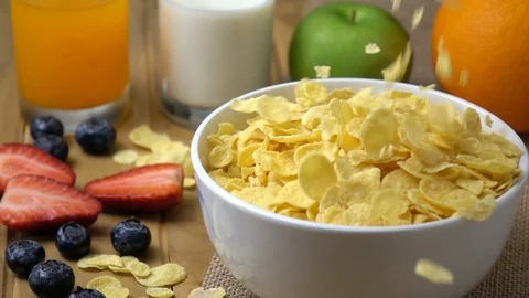 Corn flakes falling in to a bowl in slow motion. Stock Footage 94715326