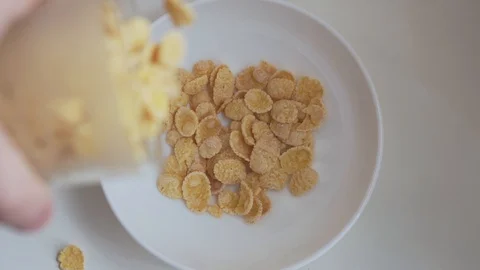 Corn flakes falling into the bowl in slow motion. Stock Footage 129234823
