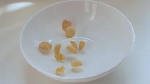 Corn flakes falling into the bowl in slow motion. Stock Footage 129234875
