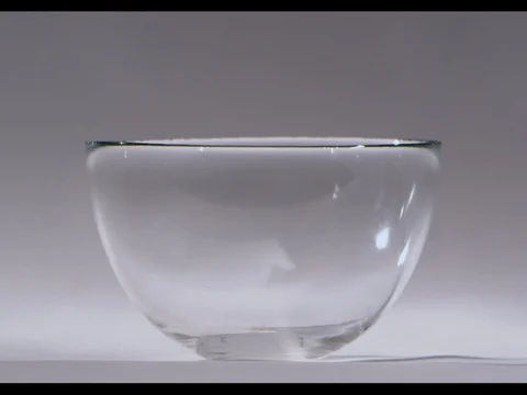 Corn flakes falling in a glass bowl filling a half of it, white background Stock Footage 74184165