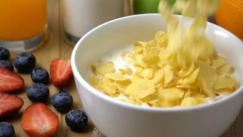 Corn flakes falling in to milk splashing in slow motion. Stock Footage 94087518