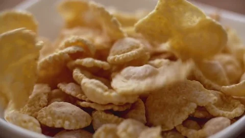Corn flakes falling in white bowl in slow motion. Close up view Stock Footage 74174639