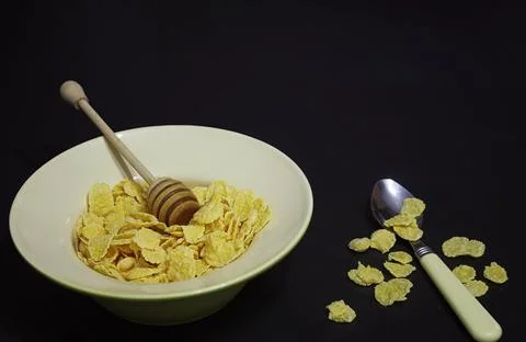 Corn flakes in a plate. Breakfast from flakes with honey and milk. Fast bre.. Stock Photos