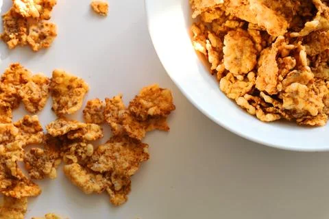 Corn flakes in a plate on a white background, close up Stock Photos