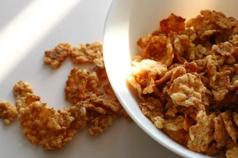 Corn flakes in a plate on a white background, close up Fotos de archivo