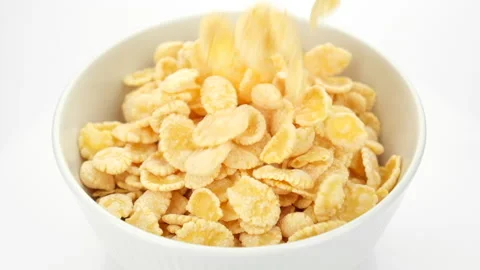 Corn flakes pour in bowl, close up. Perfect traditional breakfast Stock-Footage 234614841