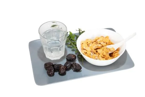 Corn flakes served with dates and cold water during fasting month of Ramadhan Stock Photos