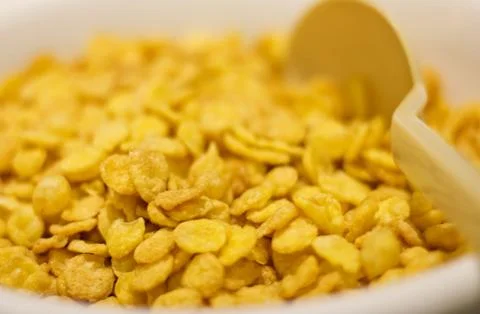 Corn flakes with spoon for breakfast. Selective focus. Macro Stock Photos