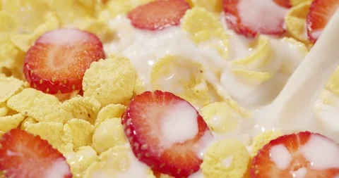 Corn Flakes with Strawberries pouring with Milk healthy food breakfast Stock Footage 125344719