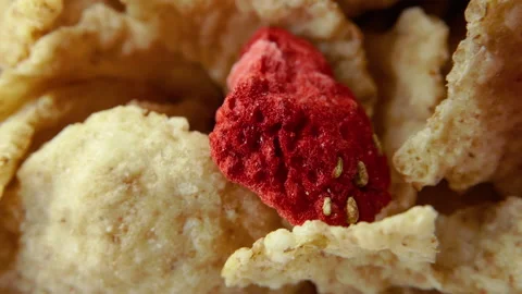 Corn flakes with strawberry in a bowl without milk rotation. 4K. macro close up Stock Footage 154740414
