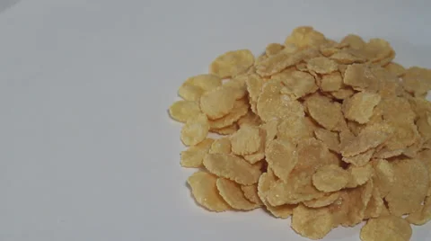 Corn flakes on white bg turning Stock Footage 33687596