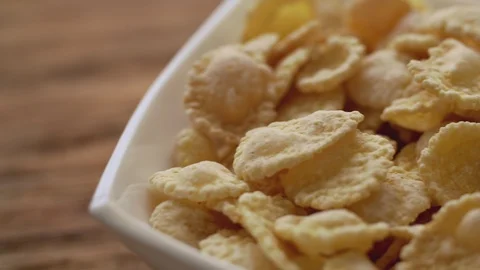 Corn flakes in white bowl in close up. Slide right Video stock 104873639
