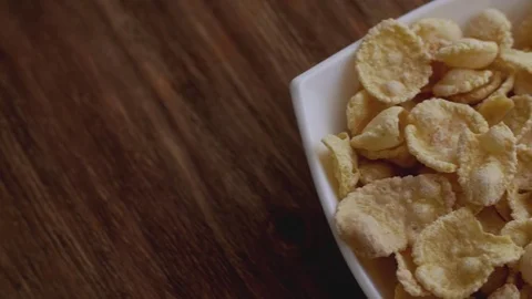Corn flakes in white bowl with copyspace to the right. Slide right Video stock 80906447