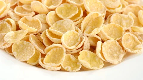 Corn flakes in white plate rotating, closeup. top view 動画素材 132042299