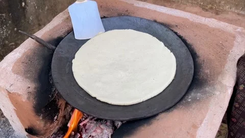 Corn Flatbread Cooking on Wooden Stove in Traditional Village Kitchen 스톡 동영상 320930905