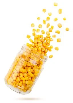 Corn flies out of a can on a white background. Isolated Stock Photos