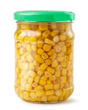 Corn in a glass jar on a white background. Isolated Stock Photos