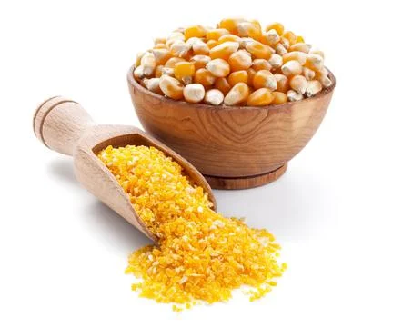 Corn grain and corn groats in a wooden bowl isolated Stock Photos