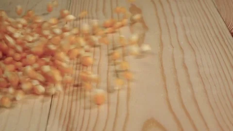 Corn grains are falling on the table. Close up. Slow motion Stock Footage 74736181