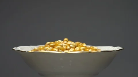 Corn grains in a bowl. Sweet maize, cereal grains. Rotation. Grey background. Stock Footage 101477044