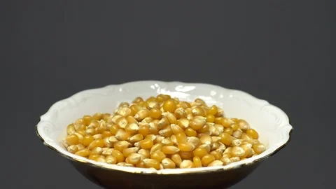 Corn grains in a bowl. Sweet maize, cereal grains. Rotation. Grey background. Stock Footage 101477577