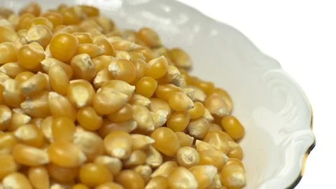 Corn grains in a bowl. Sweet maize, cereal grains. Rotation. Isolated on white. Stock Footage 101478124