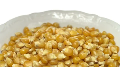 Corn grains in a bowl. Sweet maize, cereal grains. Rotation. Isolated on white. Stock Footage 101478239