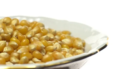 Corn grains in a bowl. Sweet maize, cereal grains. Rotation. Isolated on white. Stock Footage 101478480