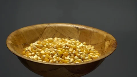 Corn grains in a bowl. Sweet maize, cereal grains. Rotation. Grey background. Stock Footage 101485331