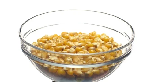 Corn grains in a bowl. Sweet maize, cereal grains. Rotation. Isolated on white. Stock Footage 101517832
