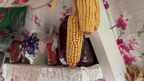 Corn Hanging Above Shelf with Preserves in Rustic Kitchen 스톡 동영상 314030544