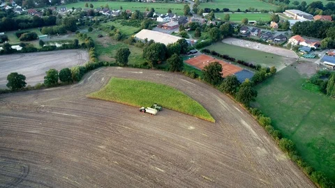 Corn harvest, corn forage harvester in action, harvest truck with tractor Video stock 94672180