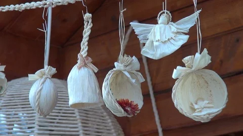 Corn husk Christmas decorations on display at fair swinging in the wind Stock Footage 86944345