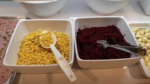 Corn Kernels and Shredded Beetroot in a Salad Buffet 스톡 사진