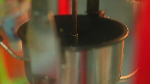 Corn kernels heating up inside a hot metal kettle of a popcorn machine Stock Footage 340513821