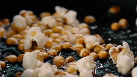 Corn kernels in a hot pan popping into popcorn Stock Footage 274644211