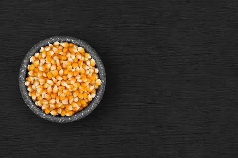 Corn kernels inside a rustic bowl 스톡 사진