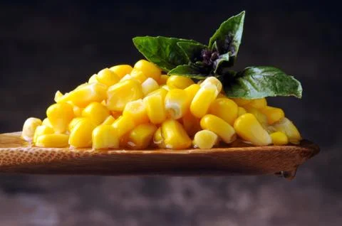 Corn kernels on spoon	 Stock Photos