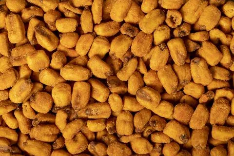 Corn nuts with sauce. Roasted corn snack close up food background. Top view.  Stock Photos