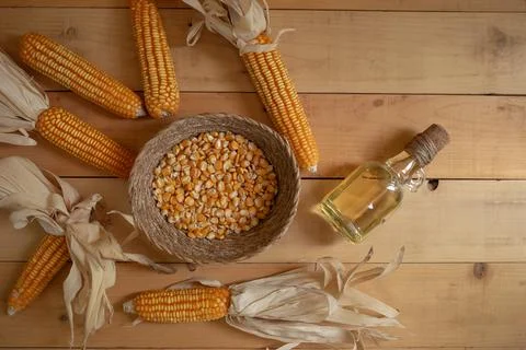 Corn oil and corn kernels on Natural pattern wood background 写真素材