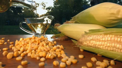 Corn oil and corn on nature. Slow motion. Close-up. Horizontal pan. Stock Footage
