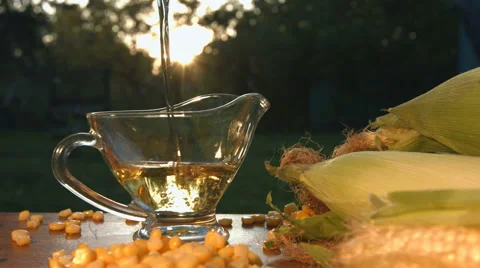 Corn oil and corn seeds on nature. Slow motion. Close-up. Vertical pan. Stock Footage