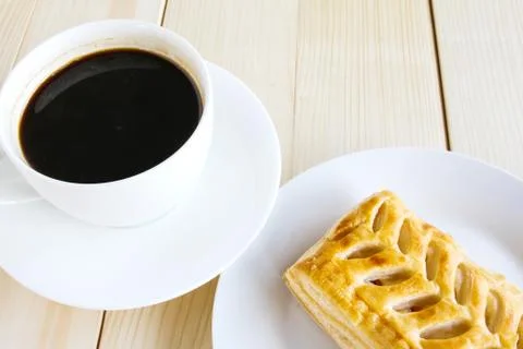 Corn pie and coffee cup on wooden background. Stock Photos